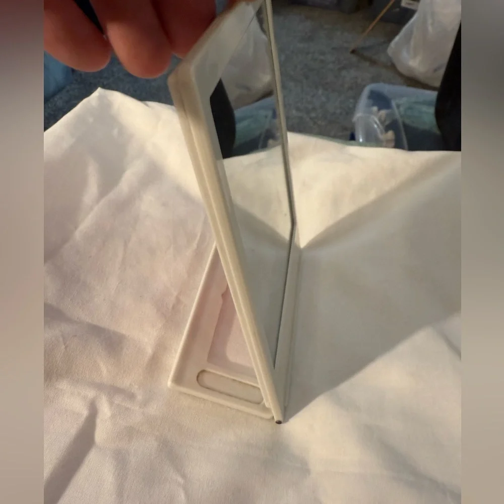 Folding Travel-style mirror - I believe it also hold a photo on the other side